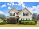 Two-story house with beige siding, shutters, and a landscaped yard at 902 Callee Dr, Loganville, GA 30052