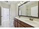 Bathroom with double vanity, large mirror, and tile floor at 2420 Bronze Ct, Cumming, GA 30041