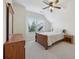Well-lit bedroom with slanted ceilings, a ceiling fan, and carpeted floors at 2420 Bronze Ct, Cumming, GA 30041