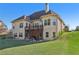 Large two-story home exterior with a spacious deck and lawn at 2420 Bronze Ct, Cumming, GA 30041