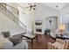 Spacious living room with vaulted ceiling, fireplace, large windows, and ample seating at 2420 Bronze Ct, Cumming, GA 30041