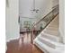 Elegant staircase with wrought-iron railing and hardwood floors at 2420 Bronze Ct, Cumming, GA 30041