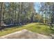 Spacious backyard with a large grassy area, partially fenced, and a patio at 197 Dixboro Dr, Jonesboro, GA 30238