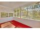 Bright sunroom with red carpet and view of backyard at 197 Dixboro Dr, Jonesboro, GA 30238