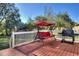 Deck with red cushions swing and grill, perfect for outdoor entertaining at 197 Dixboro Dr, Jonesboro, GA 30238