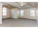 Spacious bedroom with carpet flooring and an arched window at 4815 Candy Cv, Lithonia, GA 30038