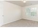 Simple bedroom with window, carpet, and neutral tones at 4815 Candy Cv, Lithonia, GA 30038