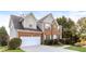 Two-story brick home with a white garage door and manicured lawn at 4815 Candy Cv, Lithonia, GA 30038