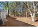Wooded backyard with pine straw and access to patio at 3015 Flat Shoals Rd, Atlanta, GA 30349