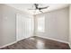 Bedroom with ceiling fan, double door closet, and dark wood-look floors at 3015 Flat Shoals Rd, Atlanta, GA 30349