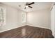 Bright bedroom with ceiling fan, large closet, and dark wood-look floors at 3015 Flat Shoals Rd, Atlanta, GA 30349