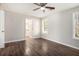 Spacious bedroom with ceiling fan, access to bathroom, and dark wood-look floors at 3015 Flat Shoals Rd, Atlanta, GA 30349