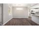 Simple dining area with dark wood-look floors and view into kitchen at 3015 Flat Shoals Rd, Atlanta, GA 30349