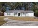 Gray sided ranch home with a curved driveway and attached garage at 3015 Flat Shoals Rd, Atlanta, GA 30349