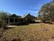 Large backyard with a view of the house and surrounding trees at 2820 Brookford Sw Ln, Atlanta, GA 30331