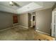 Spacious carpeted bedroom with neutral walls and a door to the hallway at 2820 Brookford Sw Ln, Atlanta, GA 30331