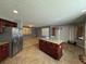 Kitchen with an island, stainless steel appliances, and tile floor at 2820 Brookford Sw Ln, Atlanta, GA 30331