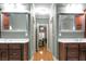 Double vanity bathroom with granite countertops and large mirrors at 620 Springview Dr, Covington, GA 30014