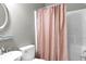 Clean bathroom with a shower/tub combo and pink curtain at 620 Springview Dr, Covington, GA 30014