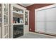 Home office with built-in shelving, fireplace, and large window at 620 Springview Dr, Covington, GA 30014