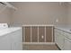 Bright laundry room with washer, dryer, and cabinets at 620 Springview Dr, Covington, GA 30014