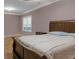 Well-lit bedroom featuring hardwood floors and a queen bed at 620 Springview Dr, Covington, GA 30014