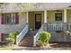 Brick house with white porch, steps, and rocking chairs at 3520 Tom Brewer Rd, Loganville, GA 30052