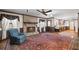 Open living room with fireplace, hardwood floors, and kitchen view at 3520 Tom Brewer Rd, Loganville, GA 30052