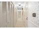 Long hallway with neutral walls, carpeting, and multiple closets at 3520 Tom Brewer Rd, Loganville, GA 30052