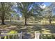 View of a pond from a house with a large yard and trees at 3520 Tom Brewer Rd, Loganville, GA 30052