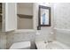 Small bathroom with pedestal sink and built-in storage at 3520 Tom Brewer Rd, Loganville, GA 30052