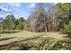 Serene pond view with lush green grass and surrounding trees at 3520 Tom Brewer Rd, Loganville, GA 30052