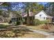 Brick ranch house with walkway, landscaping, and American flag at 3520 Tom Brewer Rd, Loganville, GA 30052