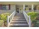Brick steps leading to a porch with white railings at 3520 Tom Brewer Rd, Loganville, GA 30052