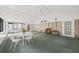 Sunroom with a wood burning stove, white table and chairs, and brick wall at 3520 Tom Brewer Rd, Loganville, GA 30052