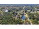 Aerial view of house, pond, and surrounding trees at 3520 Tom Brewer Rd, Loganville, GA 30052
