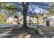 Large backyard with picnic tables, mature trees, and basketball hoop at 3520 Tom Brewer Rd, Loganville, GA 30052