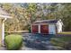 Two-car detached garage with red doors and ample parking space at 3520 Tom Brewer Rd, Loganville, GA 30052