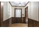 Inviting entryway with wood paneling and a chandelier at 3520 Tom Brewer Rd, Loganville, GA 30052