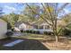 Ranch home with sunroom, detached garage, and mature trees at 3520 Tom Brewer Rd, Loganville, GA 30052