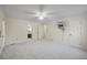 Spacious bedroom with carpet, ceiling fan, and en-suite bathroom access at 3520 Tom Brewer Rd, Loganville, GA 30052