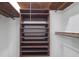 Closet with wooden shelving and hanging rods for storage at 3520 Tom Brewer Rd, Loganville, GA 30052