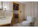 Basement bathroom features a vanity, toilet and access to unfinished basement area at 3520 Tom Brewer Rd, Loganville, GA 30052