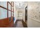 Inviting entryway with brick flooring and floral wallpaper at 3520 Tom Brewer Rd, Loganville, GA 30052