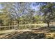 Scenic pond view with lush trees and seating area at 3520 Tom Brewer Rd, Loganville, GA 30052