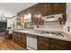 Kitchen with wood cabinets, granite countertops, and a gas cooktop at 3520 Tom Brewer Rd, Loganville, GA 30052