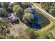 Aerial view of home and pond on wooded lot at 3520 Tom Brewer Rd, Loganville, GA 30052