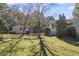 Landscaped backyard with detached garage and large trees at 3520 Tom Brewer Rd, Loganville, GA 30052