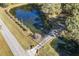 Aerial view showing home, pond, and driveway at 3520 Tom Brewer Rd, Loganville, GA 30052