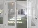 Sunroom with ample natural light and green carpeting at 3520 Tom Brewer Rd, Loganville, GA 30052